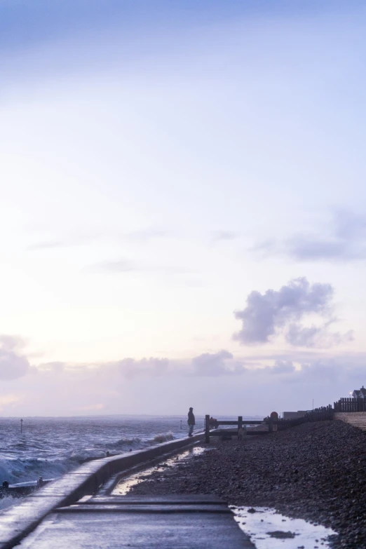 a pier on the ocean near a cliff