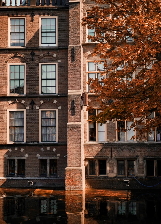 a large building sits beside a body of water