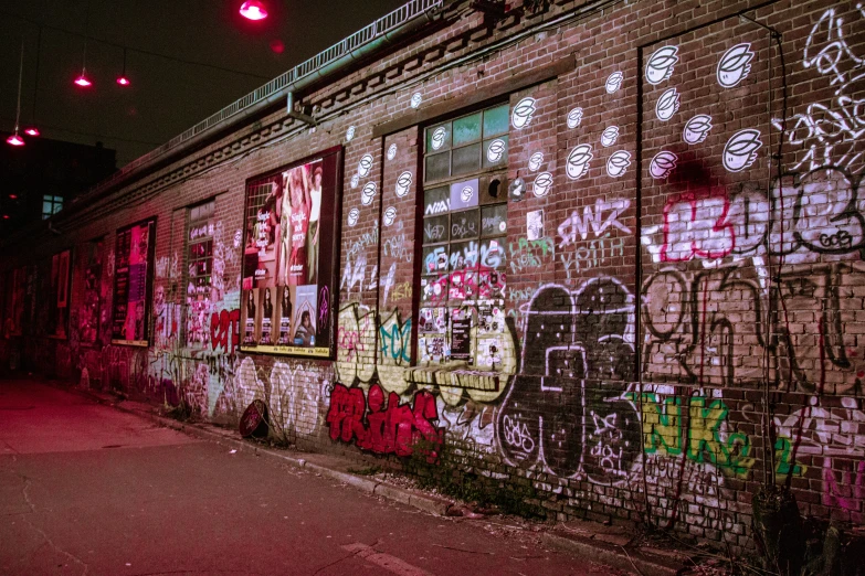 an alleyway covered in graffiti and window frames