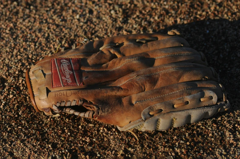 an old baseball glove laying on the ground