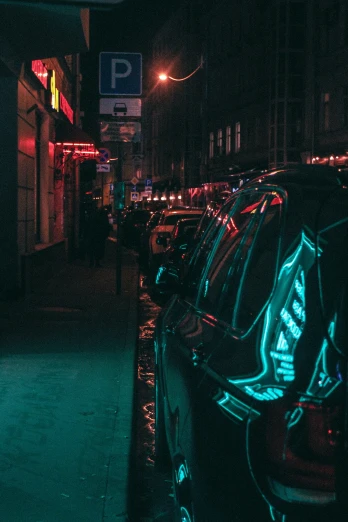 car parked outside a building at night with neon signs