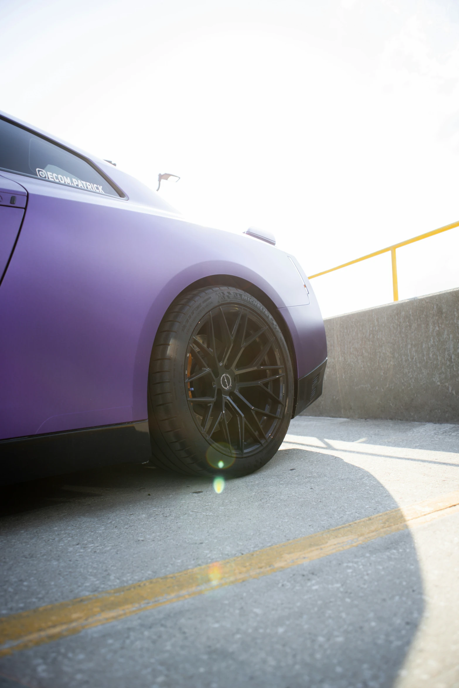 this car is purple and has black wheels