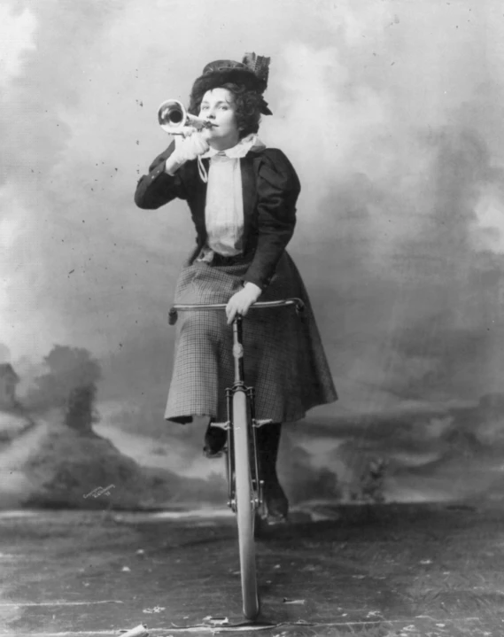 an old fashioned black and white po of a woman holding a bat