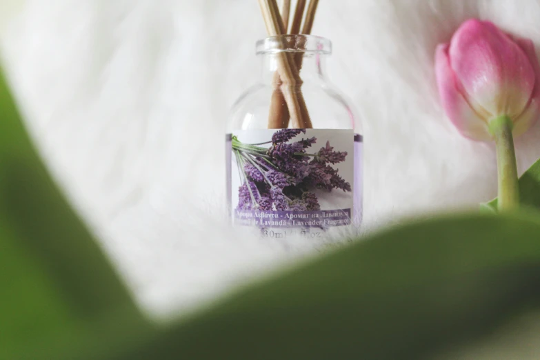 three sticks in a small jar that is sitting on a table