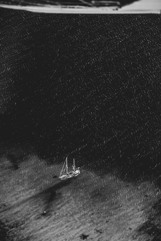 a very small boat in the dark ocean