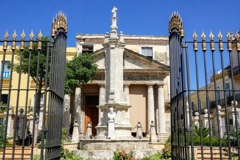 a building with a tower that has statues of birds in it