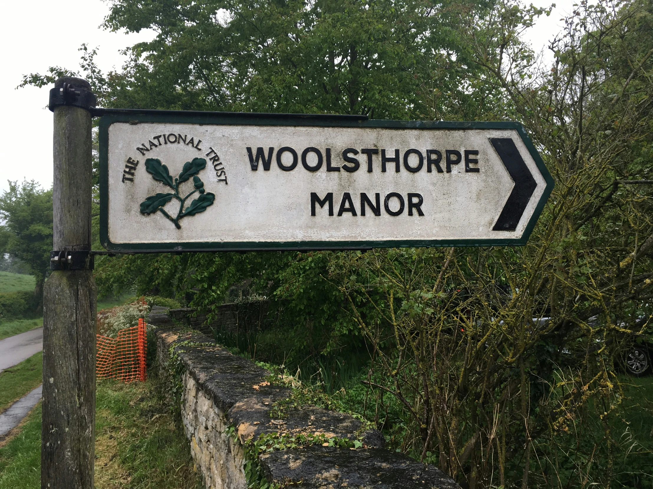 a sign pointing to two towns and a trail