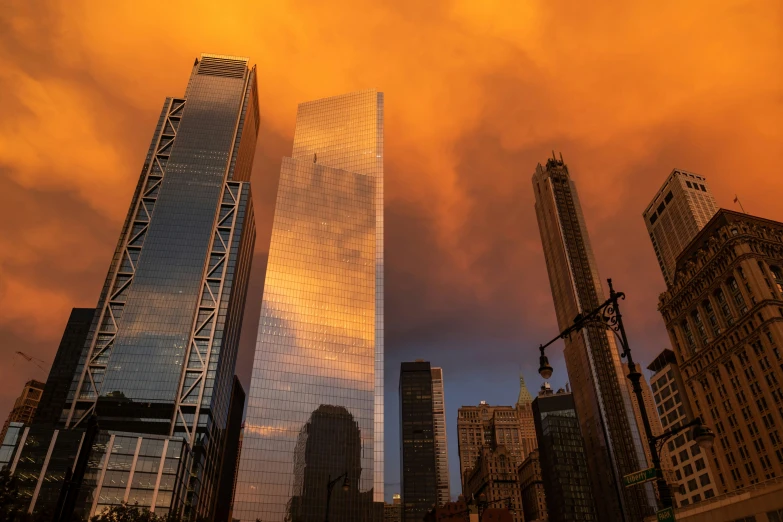 the sky is full of clouds above the skyscrs