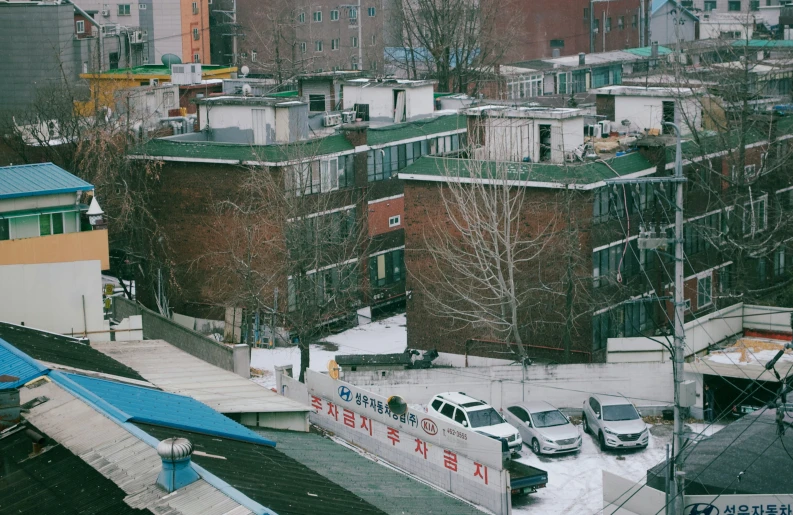 cars and a bus driving through a city in the snow