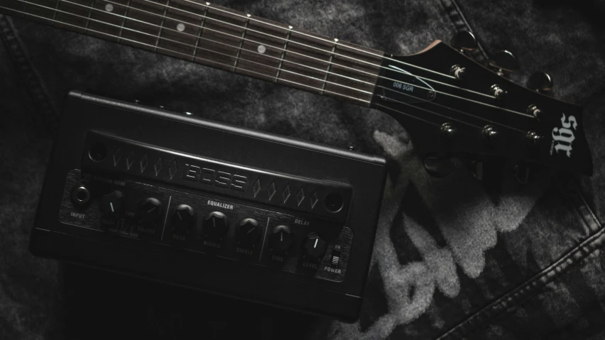 a guitar and amplifier lying next to each other