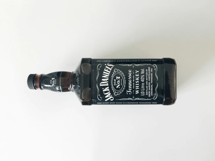 a bottle of whiskey is lying on the floor