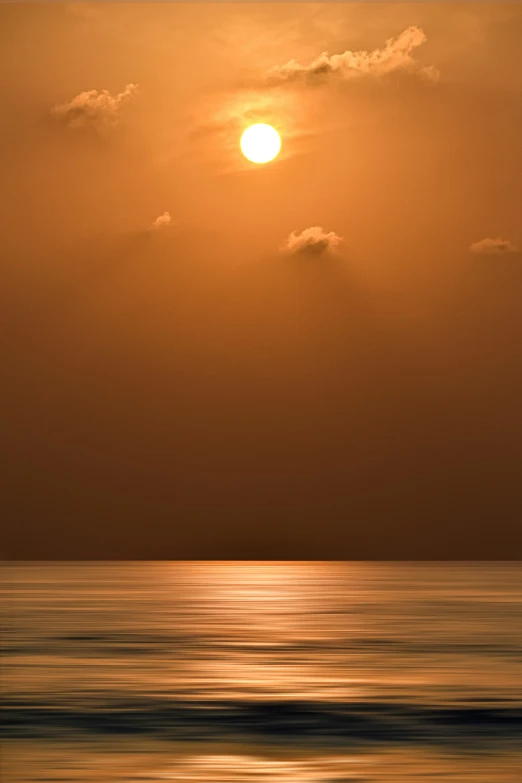 the sun is shining through the clouds above a body of water