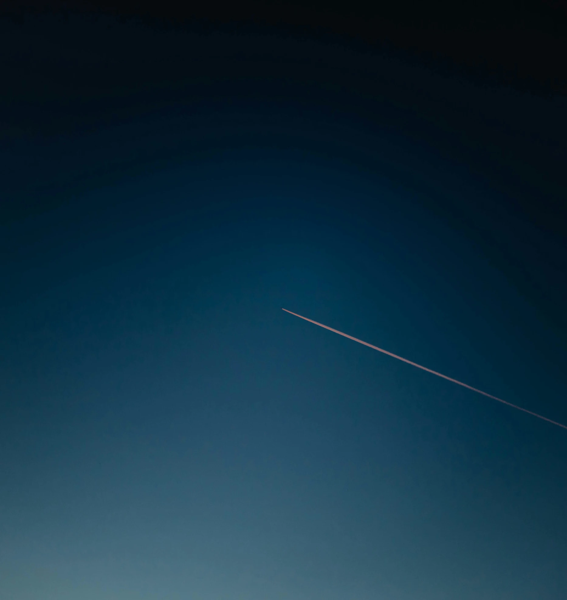 an airplane is flying high in the sky with the moon behind it