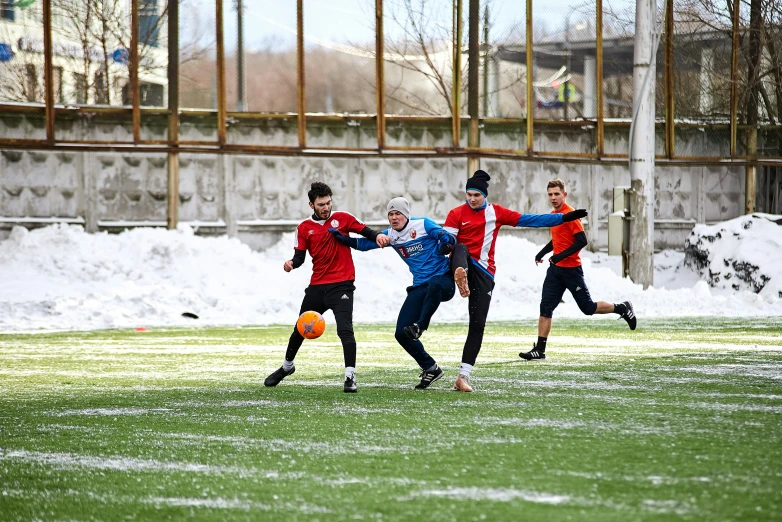 a group of young men playing soccer on a field