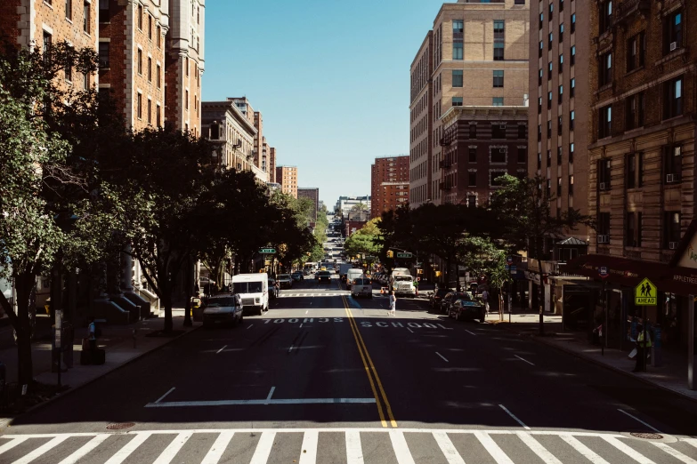 a cross walk on a narrow street between large buildings