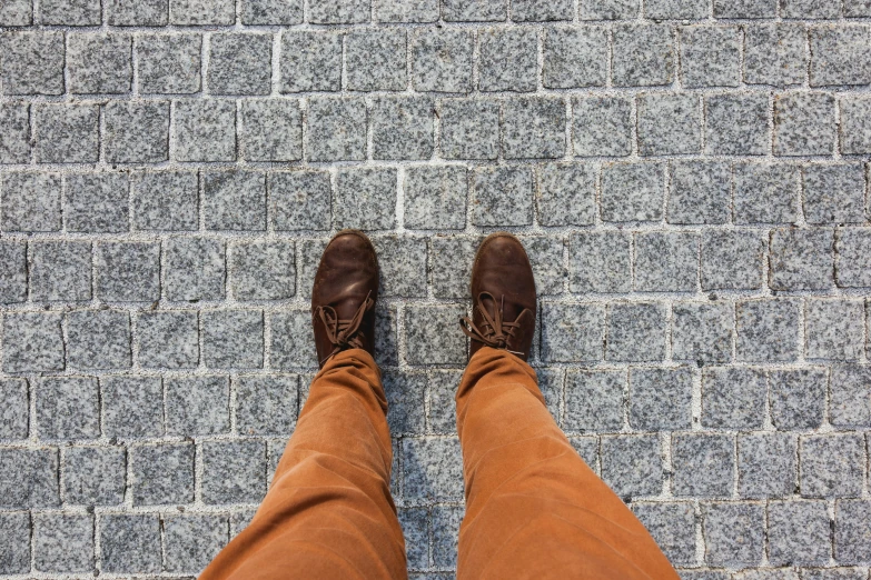 a man standing on top of a brick walkway