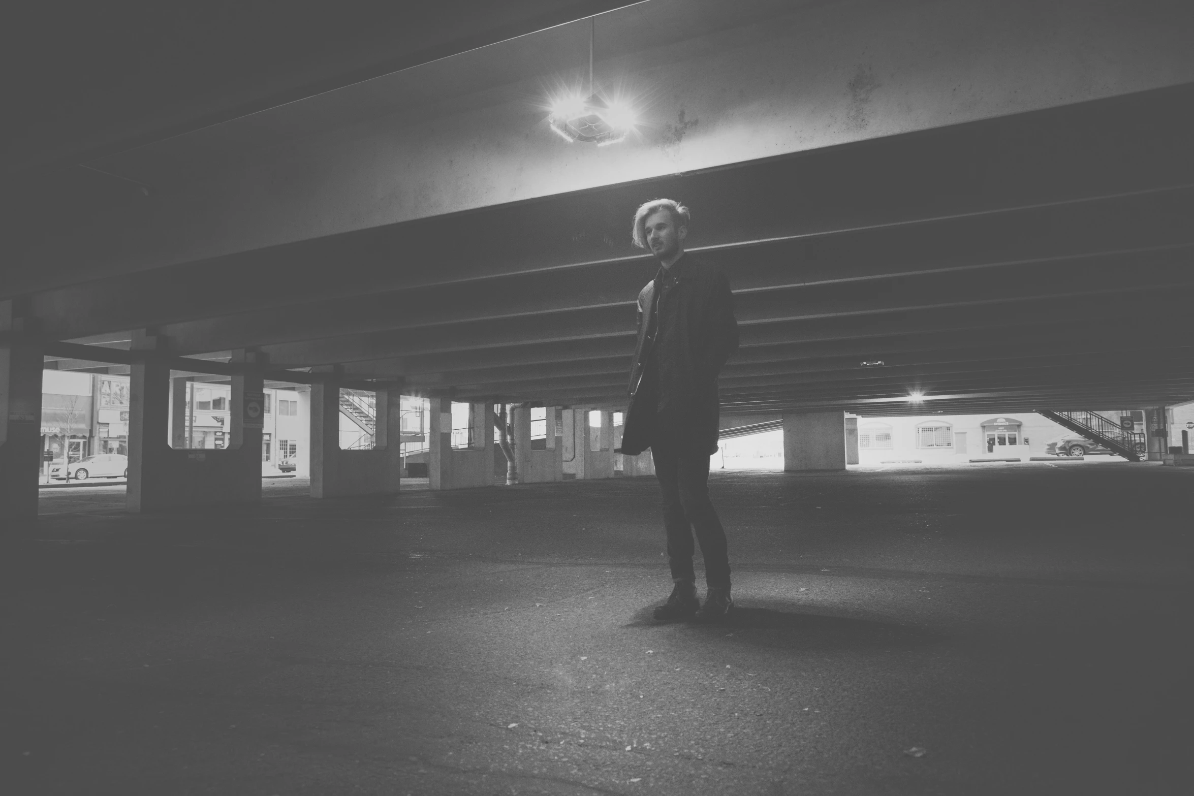 a person standing alone in an empty parking lot