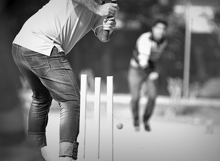 two men that are playing a game of bowls