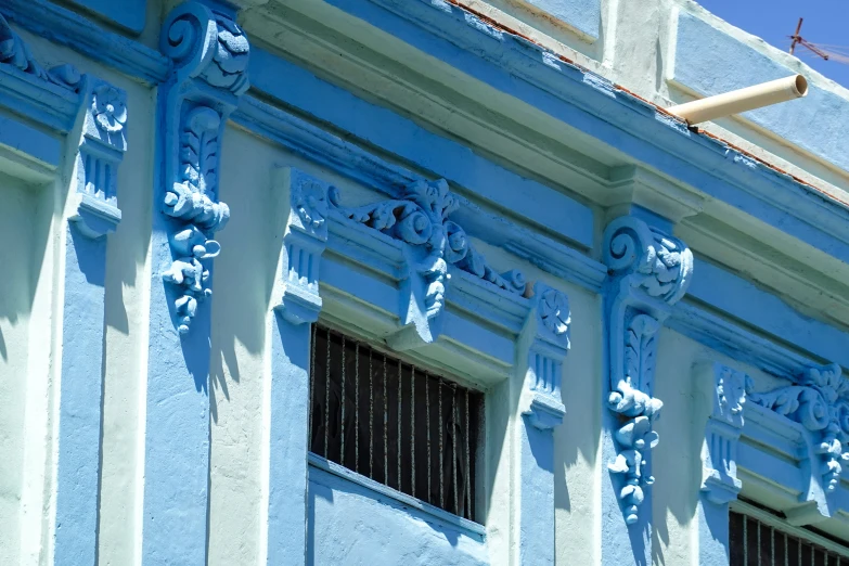a blue and white building has decorative accents
