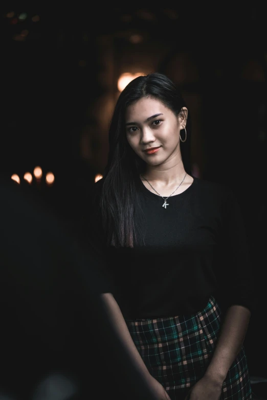 a woman standing next to other people in dark room