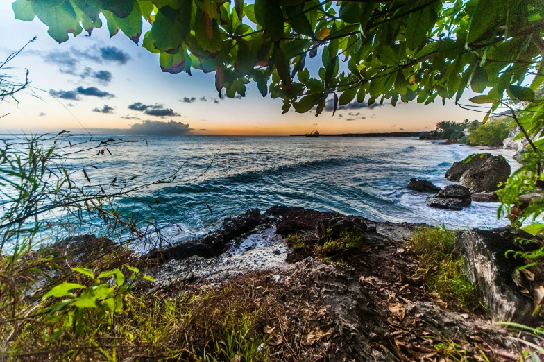 a rocky coast is shown during the sunset