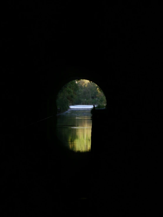a view of a river through an open tunnel