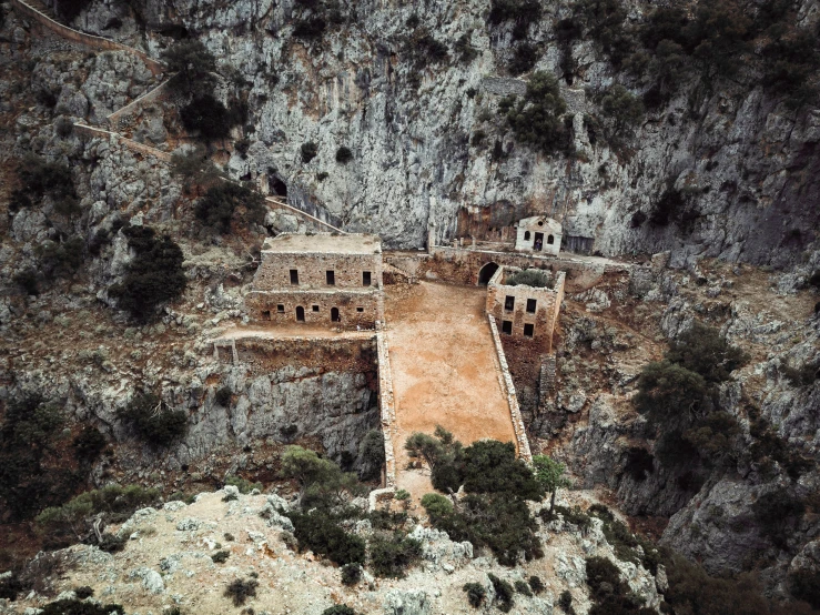 an aerial po of an ancient building in a mountain