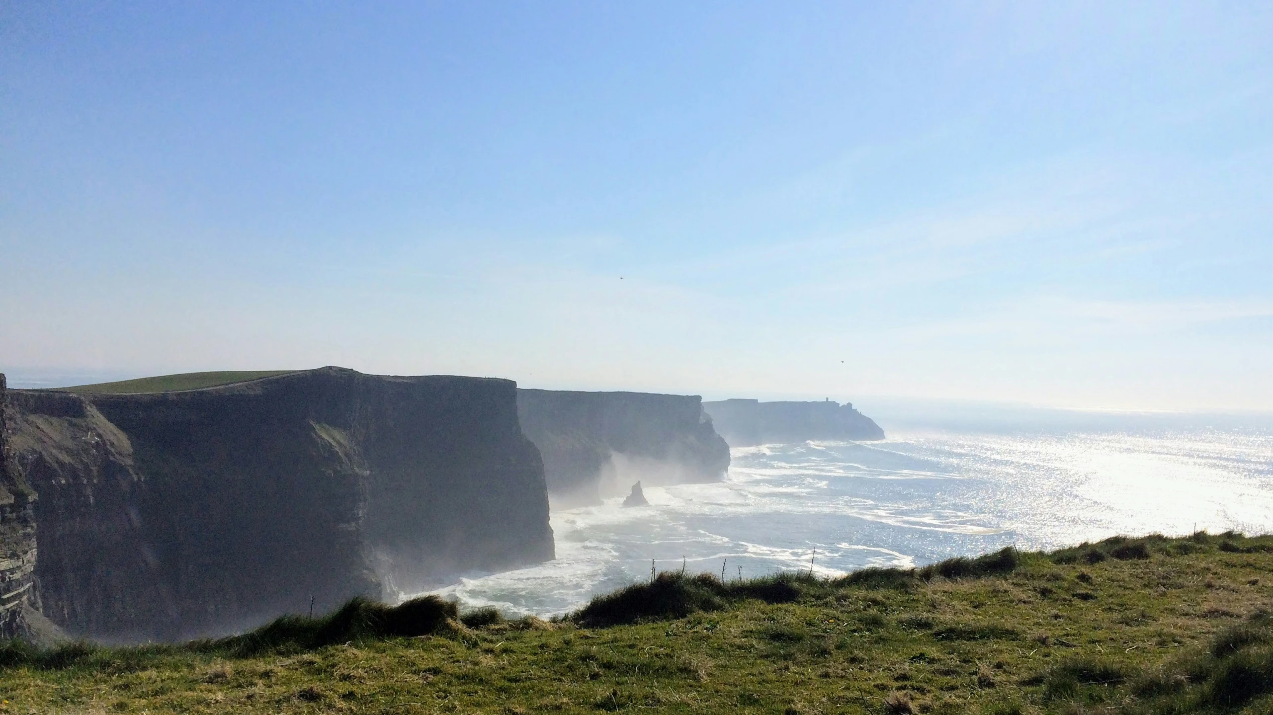 the large cliffs are high above the water