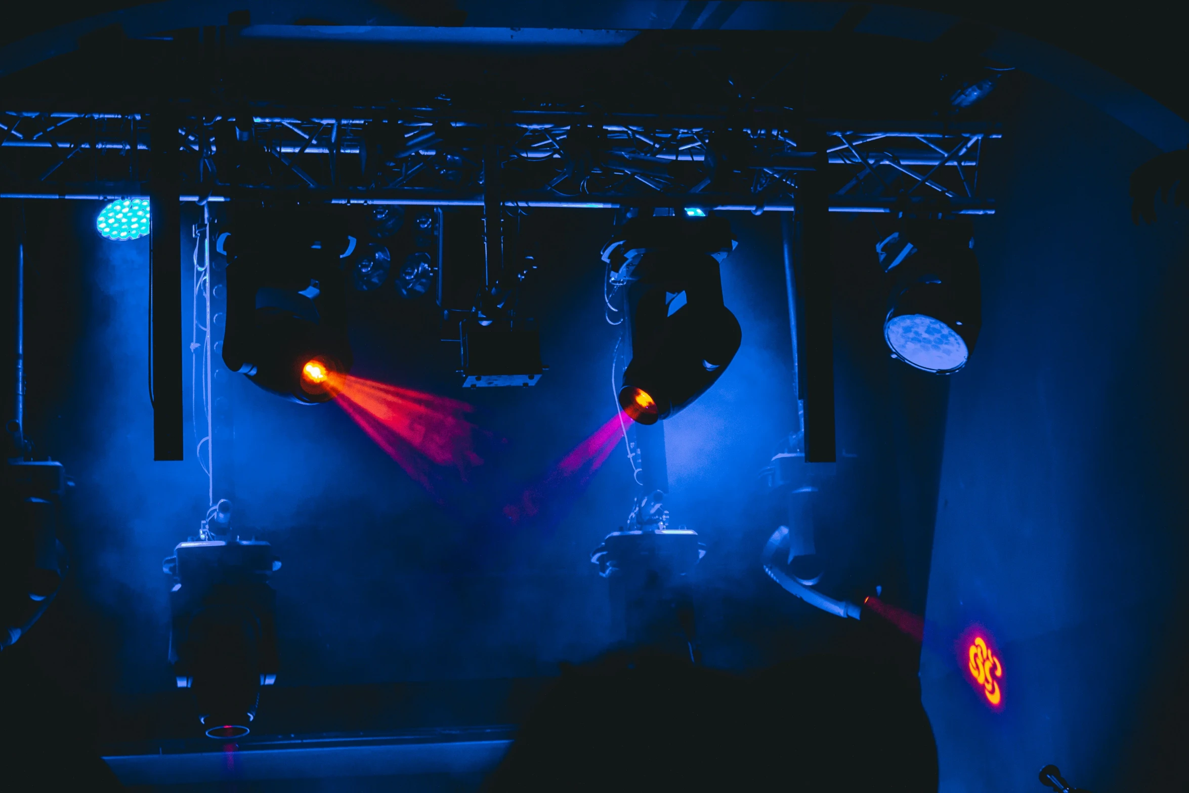 the silhouettes of two people in front of an electric stage