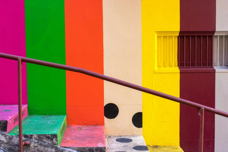 a colorful house has a staircase leading down to it