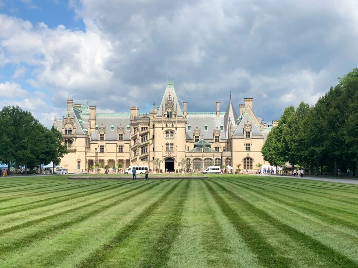 a large building with lots of windows and lawn