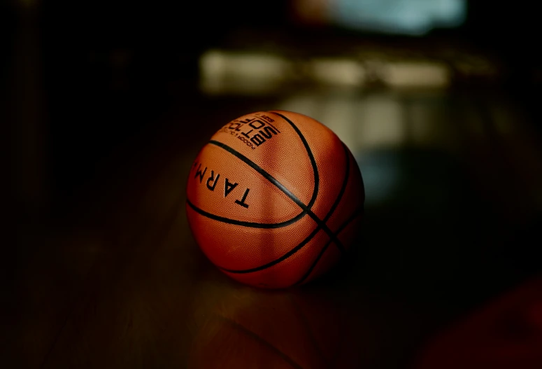 a basketball that is sitting on top of a wooden table