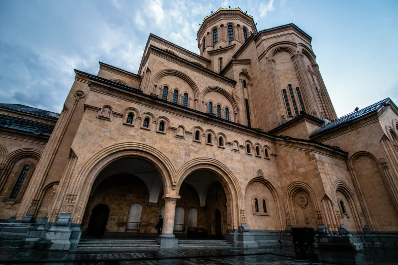 an old church with three towers and pillars in front of a building