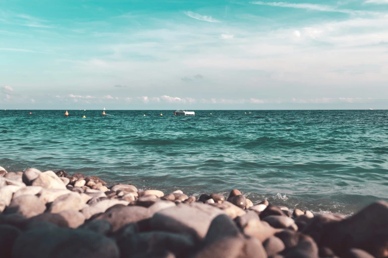 people out in the ocean on the rocky shore