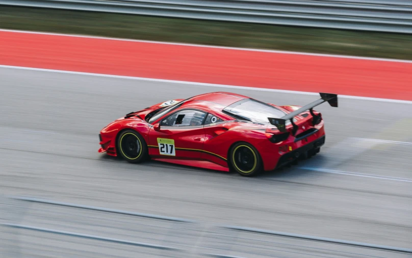 a racing car that is on the track with two hands