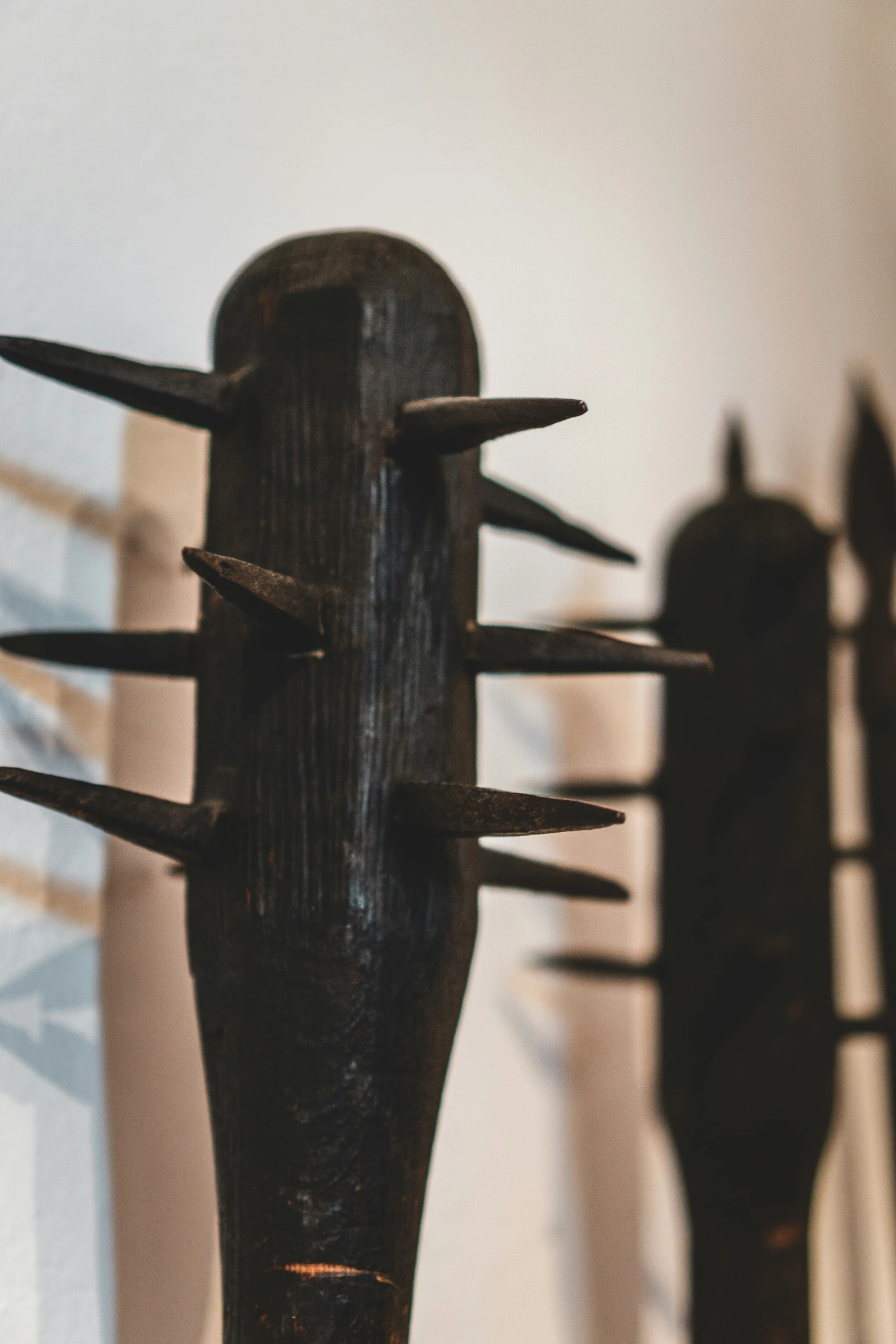 a black sculpture made of nails with black paint on it