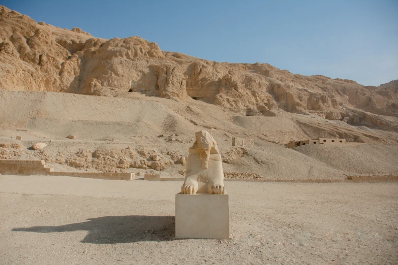 a small lion statue in the middle of an empty area