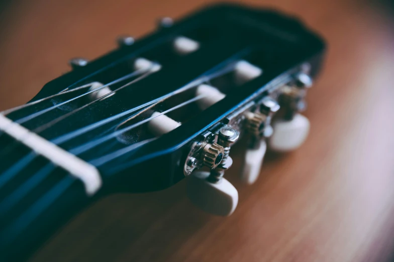 the strings of an electric guitar that is lying down on a table