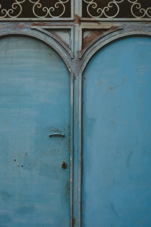 the side door is blue and has decorative ironwork