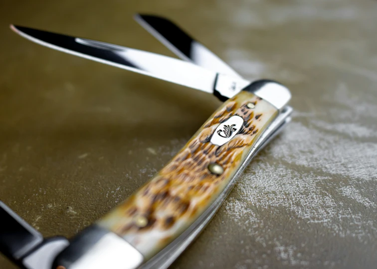 a close up of scissors with a brown background