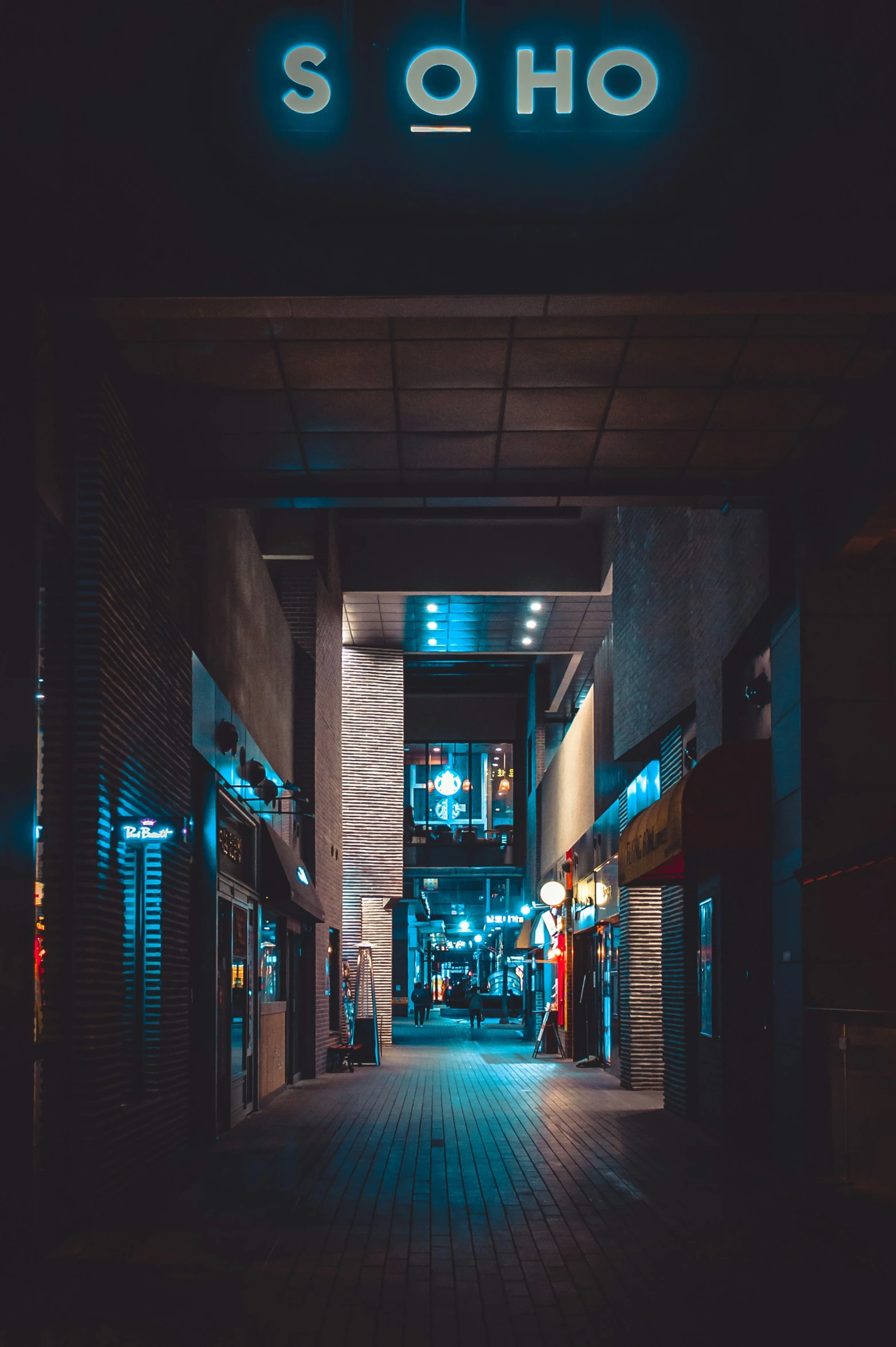 neon lit shop entrance with blue light coming through