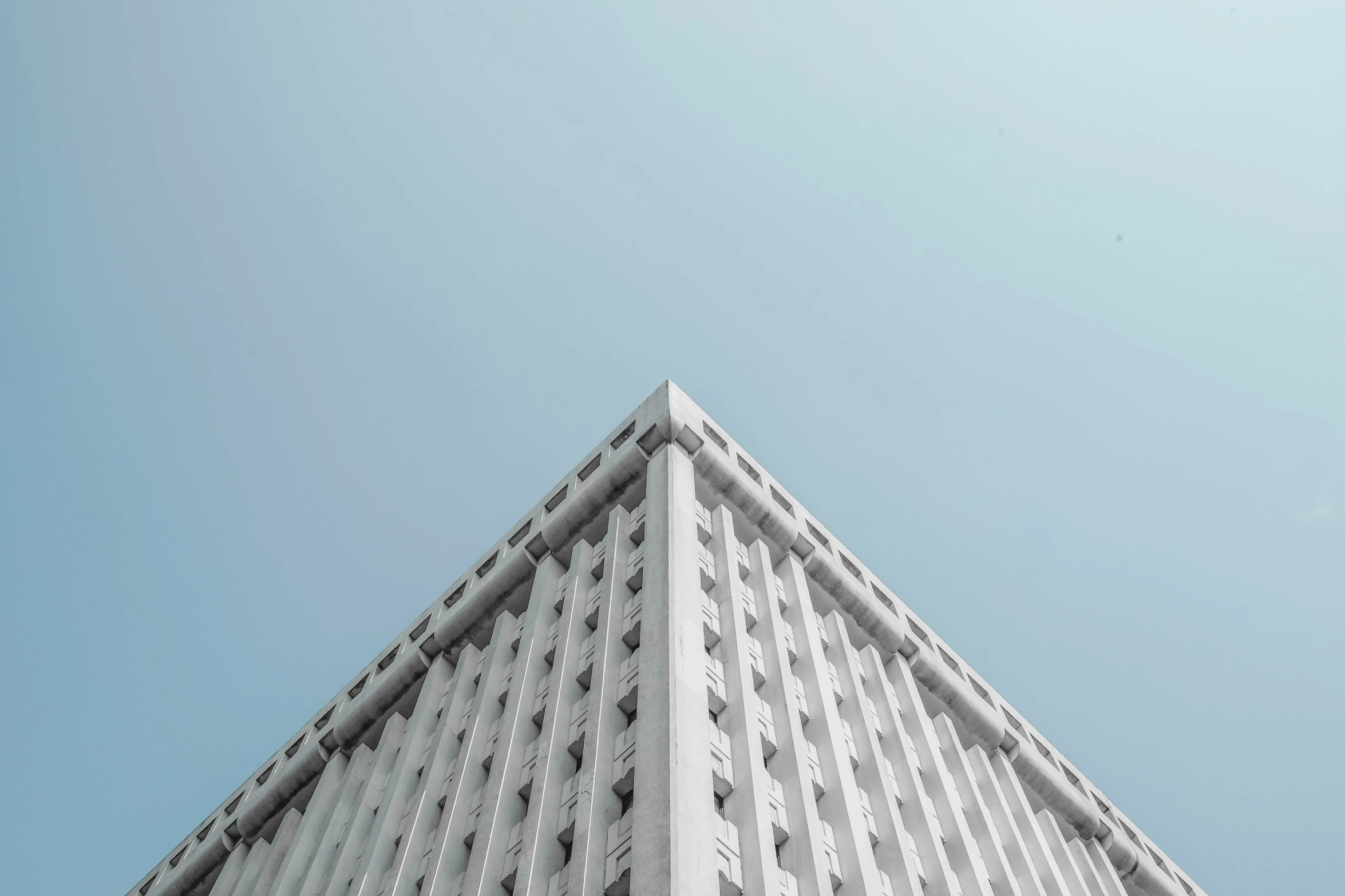 a large building with geometric shapes under a blue sky