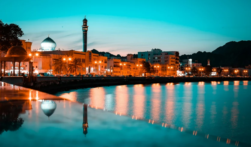 an evening scene of a city on the river