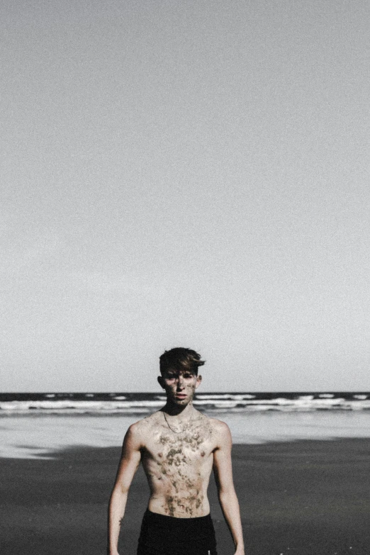 a guy with short and black shorts on the beach