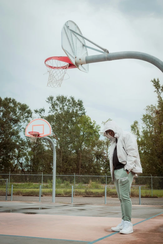 man standing on concrete and playing basketball