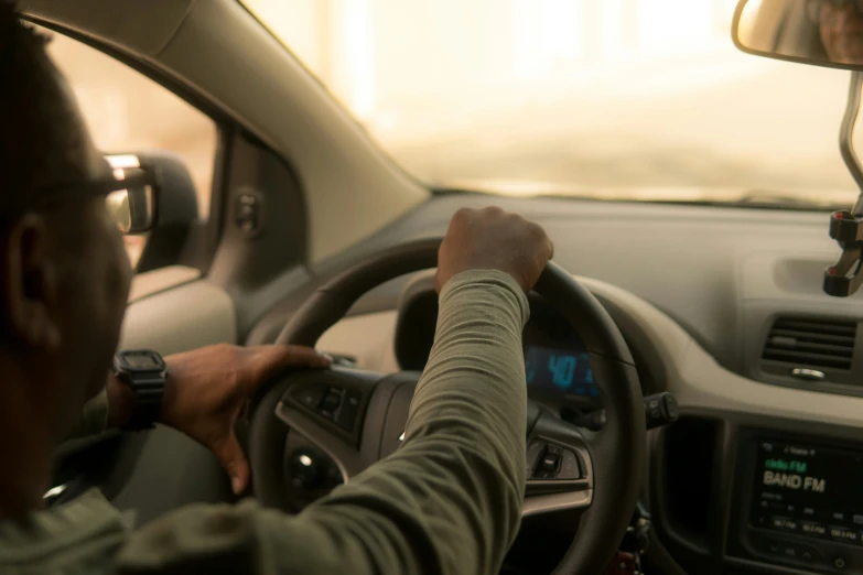 the man is driving his car using the navigation device