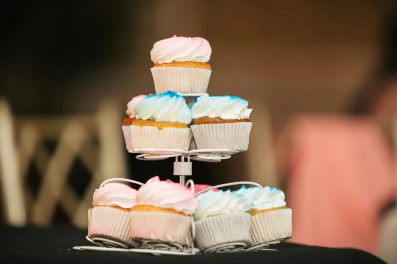 a table topped with cup cakes covered in frosting