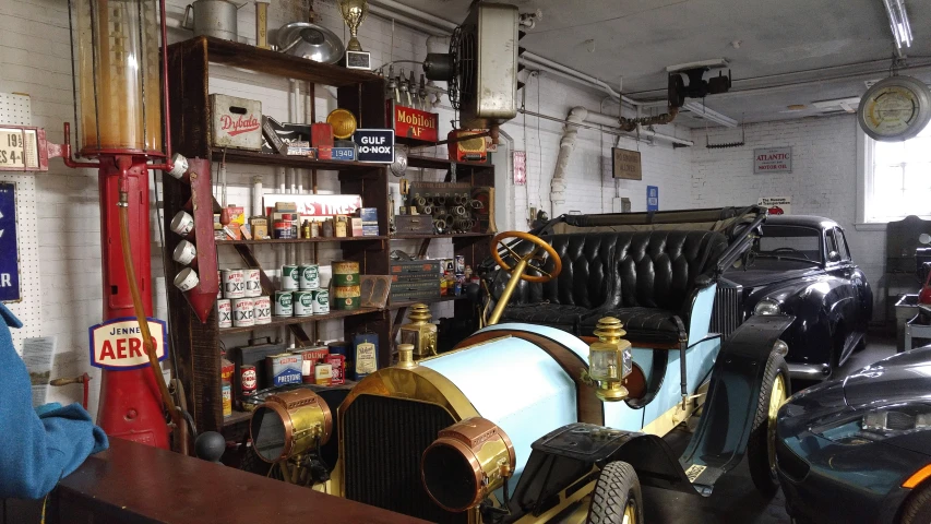 the garage is filled with antique automobiles, parts and supplies