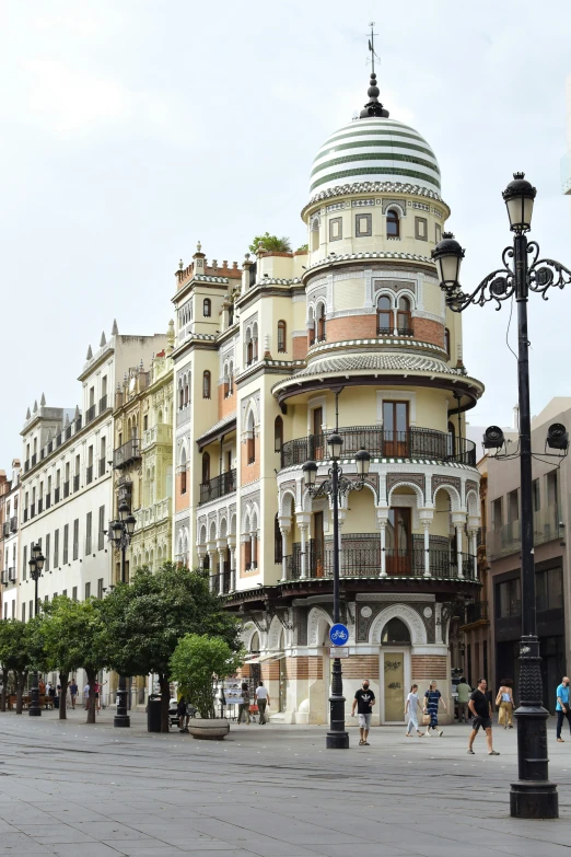 a large building in front of some trees and people