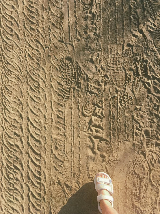 someone's sandals that are left on the sand